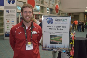 Anderson with signage featuring his winning design at the 2016 STMA Conference in San Diego.