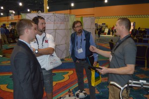 (Far right) Liam Philpotts, general manager, U.S. Fleet, explains to a group of attendees how the company's Beamrider technology works.