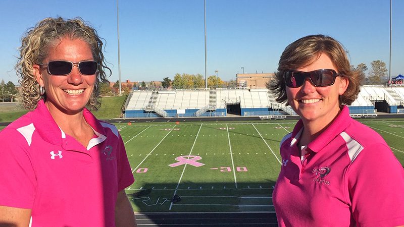 Christi Clay, CSFM (left) and Sun Roesslein, CSFM at an October "Pink Games" for breast cancer awareness. Roesslein says it's unusual in the sports turf industry to have two women working at one complex. (Photo courtsey of Christi Clay)