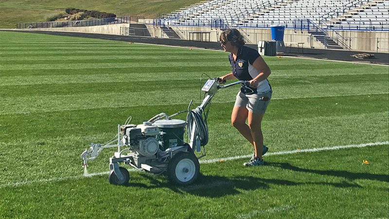 Roesslein paints lines on the football field to prepare for gameday at North Area Athletic Complex in Arvada, Colo. (Photo: Christi Clay)