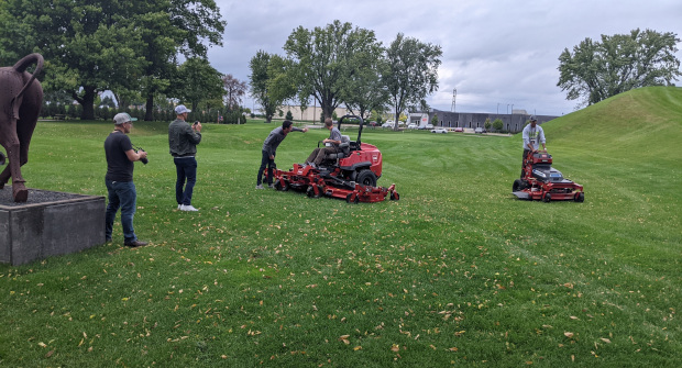 Visitors to Toro’s Minneapolis headquarters test the company’s 144-inch zero-turn mower (left) and the GrandStand Revolution electric stand-on mower (right). (Photo: ATN Staff)