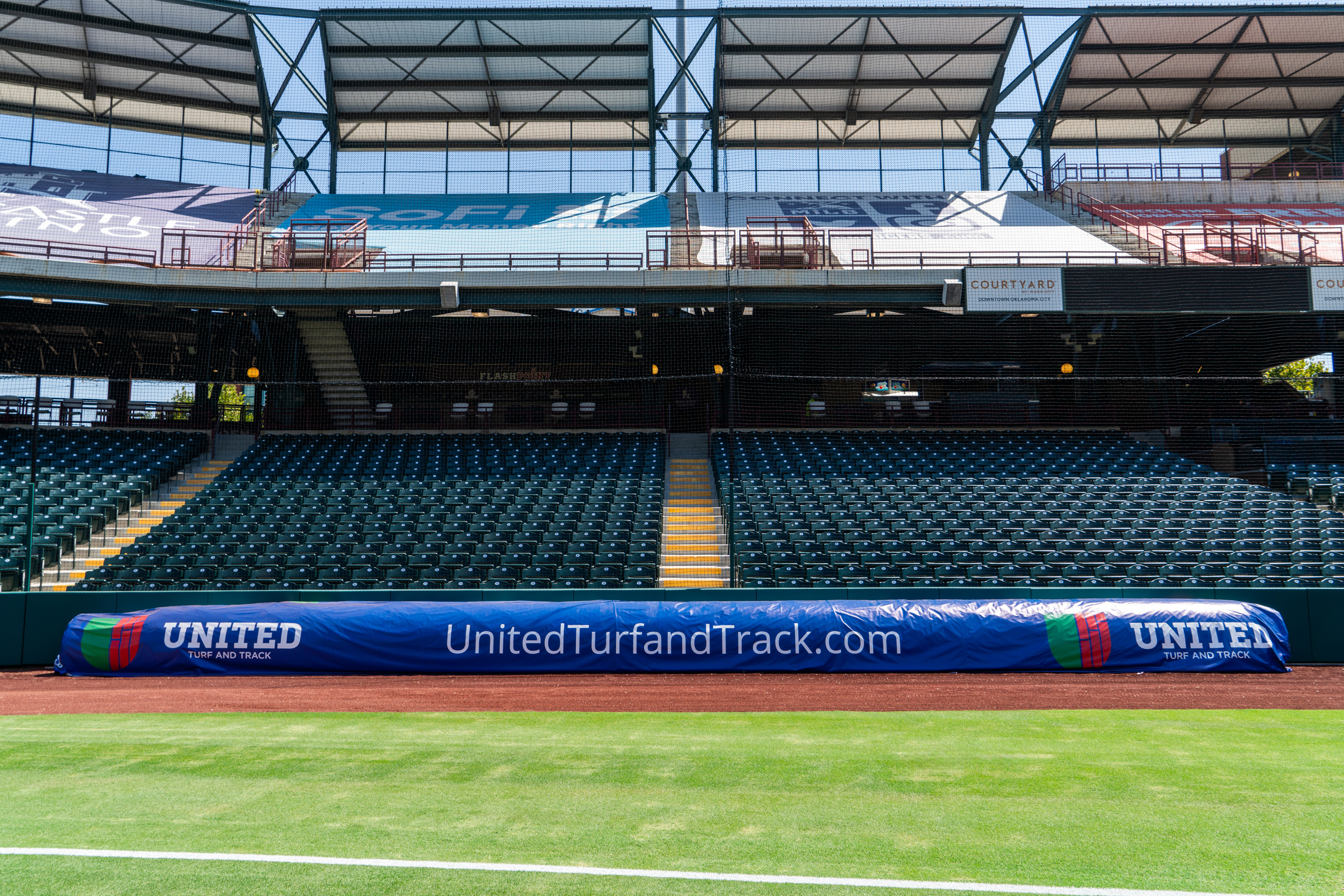 United Turf and Track tarp cover in front of the stands along the first baseline at Chickasaw Bricktown Ballpark. (Photo: United Turf and Track)